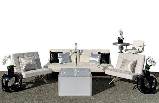 white split back sofa seating group with white barcelona chairs acrylic coffee table and black end tables